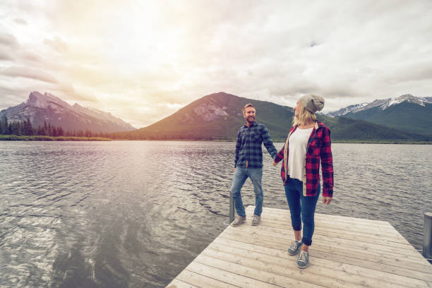 istock Two young adults enjoying nature by the lake 859350502