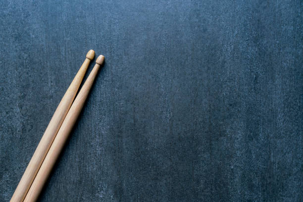 istock Drum stick on black table background, top view, music concept 859357356