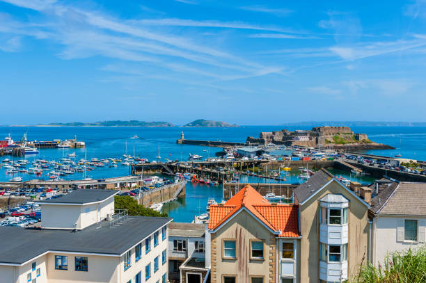 View over Harbor of Saint Peter Port Guernsey High angle view over Harbor of Saint Peter Port, Guernsey, Channel Islands, UK. The Islands of Herm and Sark are visible in the distance. channel islands england stock pictures, royalty-free photos & images