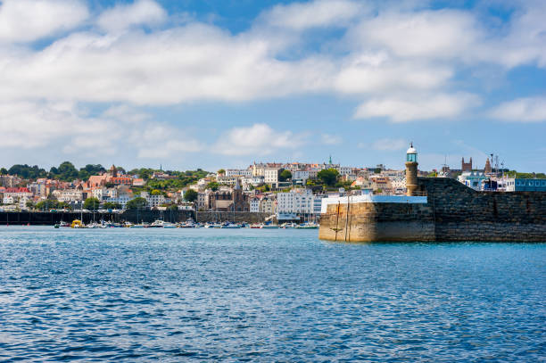 Entrance to Harbor of Saint Peter Port Guernsey Entrance to Harbor of Saint Peter Port, Guernsey, Channel Islands, UK. guernsey city stock pictures, royalty-free photos & images