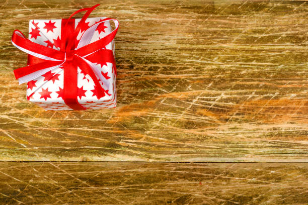 istock Christmas composition. A large white with red stars Christmas present  lie on a white and blue surface. Concept of gifts for Christmas. Copy space. 859364124