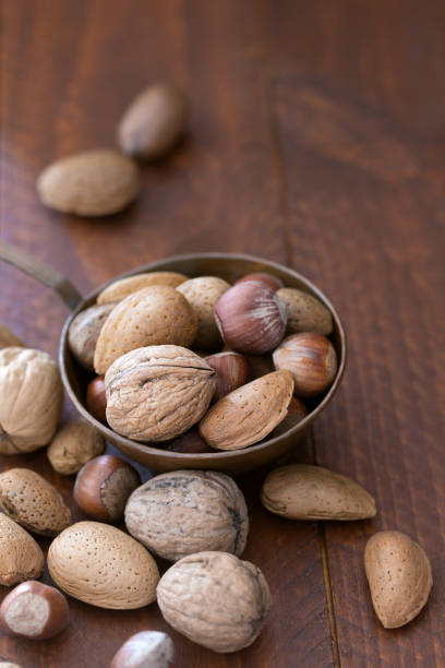istock Nuts mix in a metallic bowl on the wooden table 859364356