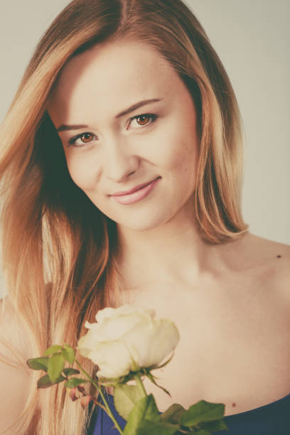 istock woman holding white rose 859367934
