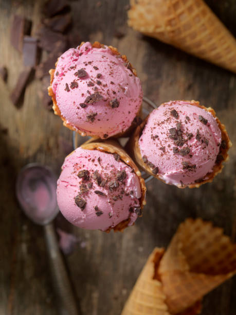 istock Strawberry Ice Cream With Chocolate Shavings in a Waffle Cone 859371578