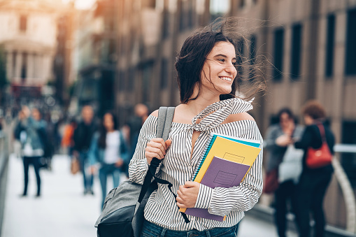 Smiling student walking on the street