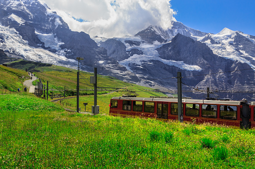 Famous red train from Kleine Scheidegg to Jungfraujoch (Top of Europe) in summer. Kleine Scheidegg, Bernese Oberland, Switzerland