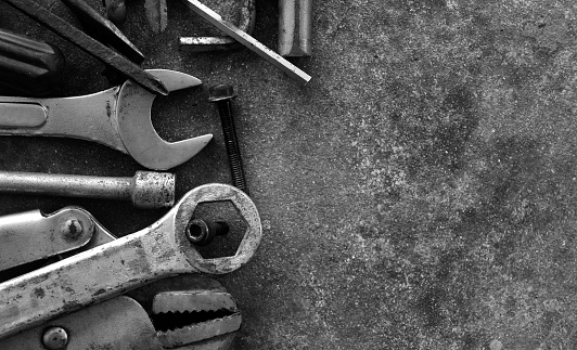 many tool on cement ground in black and white photography