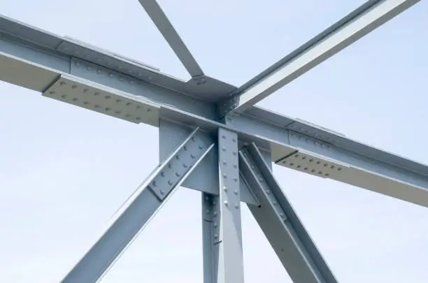 Photo of Parts of gray steel construction of a bridge