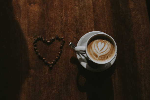 istock Coffee Cup with Latte Art and Coffee Beans Heart 859388726
