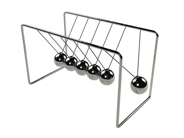 Newton's cradle in motion, silver cradle on white surface close up of a Newton's cradle, isolated on white background desk toy stock pictures, royalty-free photos & images