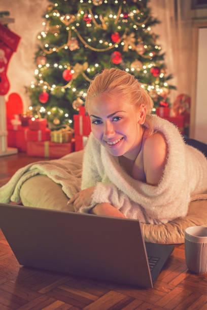 istock Young beautiful girl using laptop on Christmas night 859396370