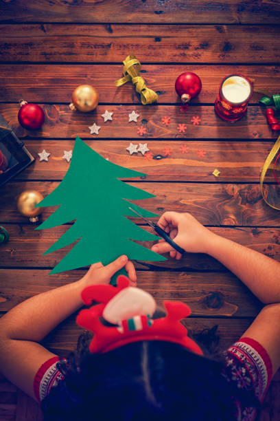istock Little Girl Making Christmas Card 859396474