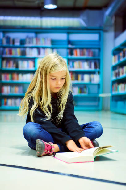 istock Child girl in library 859396678
