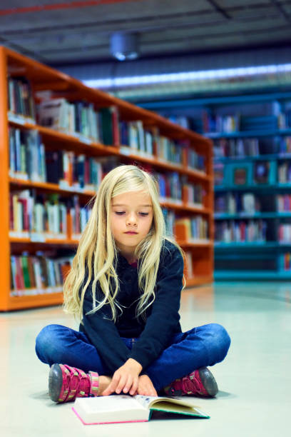 istock Child girl in library 859396714