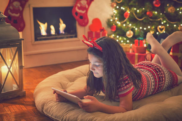 istock Beautiful little girl using digital tablet on Christmas night 859396822