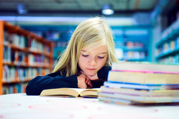 istock Child girl in library 859396976