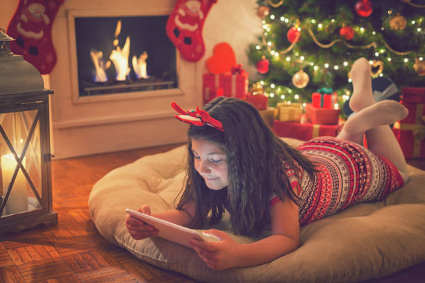 istock Beautiful little girl using digital tablet on Christmas night 859397234