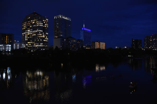 istock Night skyline over river with lighted buildings 859397316