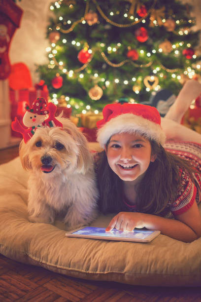 istock Beautiful little girl using digital tablet on Christmas night 859397754