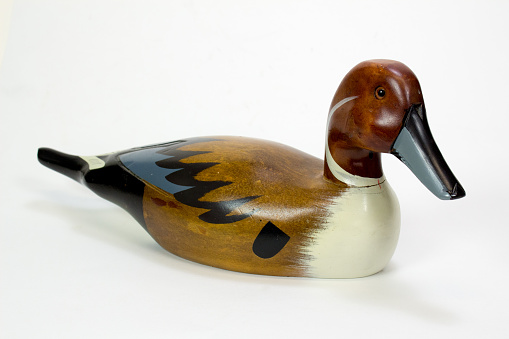 Wooden duck decoy on white background