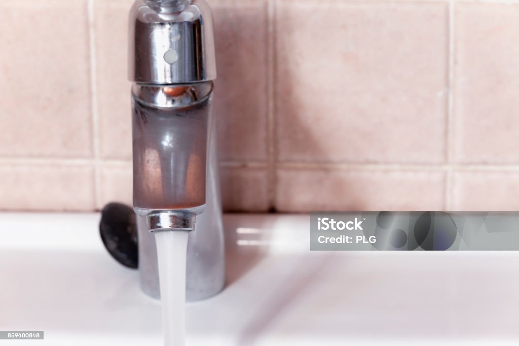 Open faucet. Open faucet letting the water run. Accidents and Disasters Stock Photo