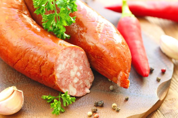 istock Smoked sausage with spices and greens 859407600