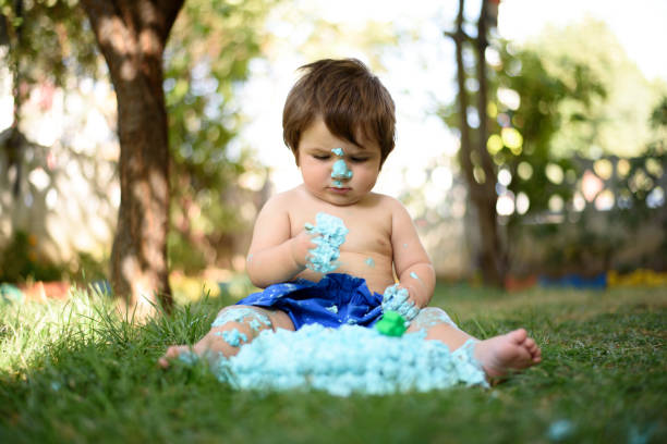 Baby playing with a cake during cake smash birthday party