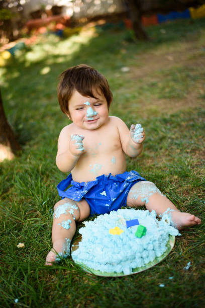 istock Baby playing with a cake during cake smash birthday party 859408290