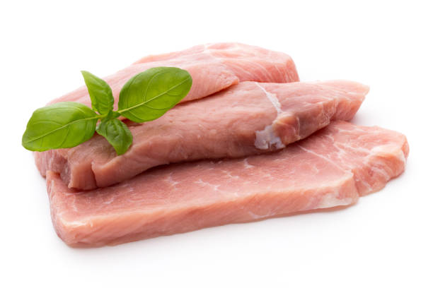 istock Fresh pork fillet with basil on a white background. 859410120