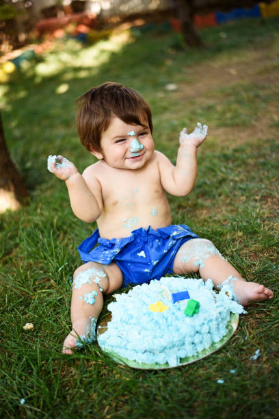 istock Baby playing with a cake during cake smash birthday party 859410178