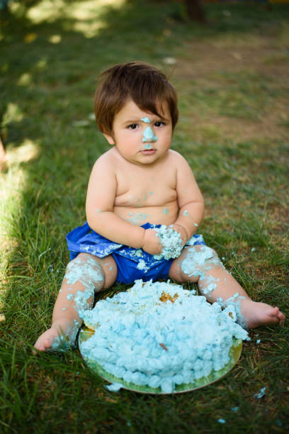istock Baby playing with a cake during cake smash birthday party 859410326