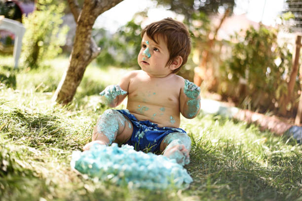 istock Baby playing with a cake during cake smash birthday party 859410450