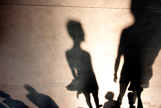istock Blurry shadows silhouettes of people 859410962