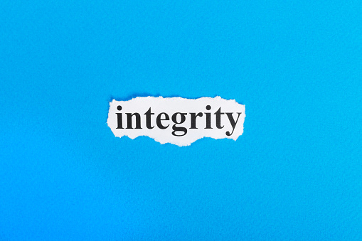 Integrity text on paper. Word Integrity on torn paper. Concept Image.
