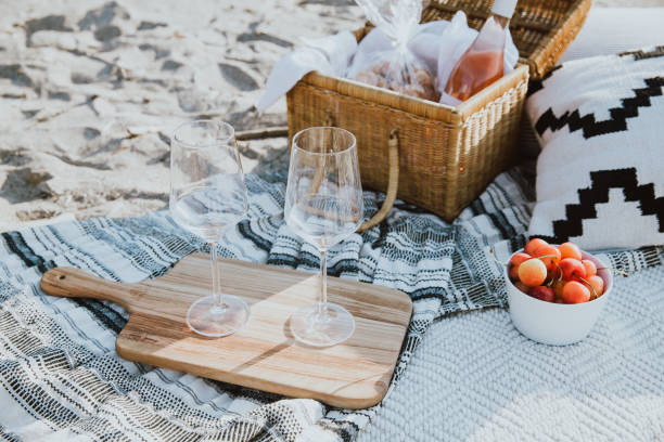 Beach Picnic Spread with Wine Glasses and Basket