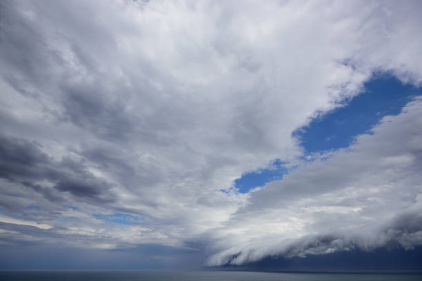 istock Epic supercell shelf cloud, Small boat fleeing 859414274