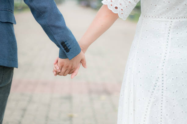 istock couple holding hands in park,pastel tone 859425440
