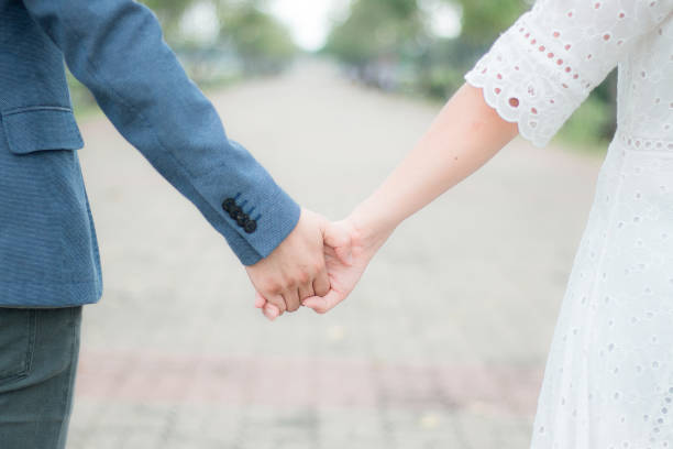 istock couple holding hands in park,pastel tone 859425580