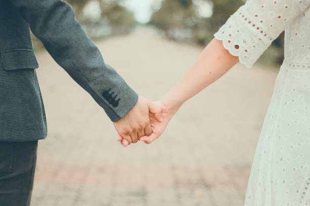 istock couple holding hands in park,pastel tone 859426176