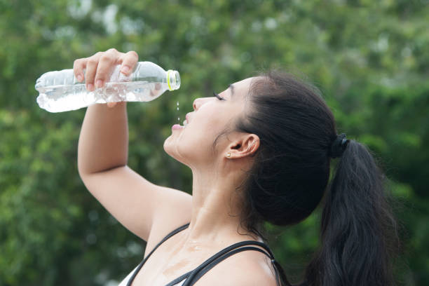 istock Sporty Asian woman drinking water. 859430834