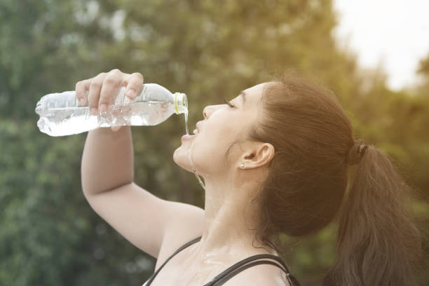 istock Sporty Asian woman drinking water. 859431206
