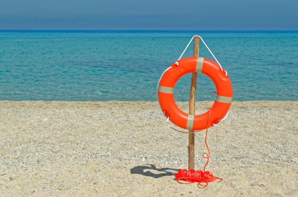 istock Life buoy on the sandy beach 859431312