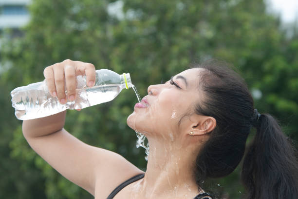 istock Sporty Asian woman drinking water. 859432590