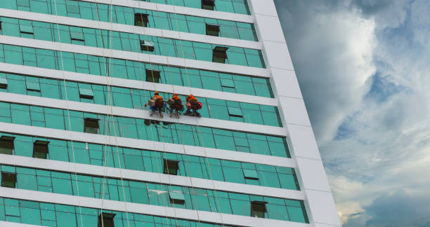 istock worker cleaning high tower in big city 859435252