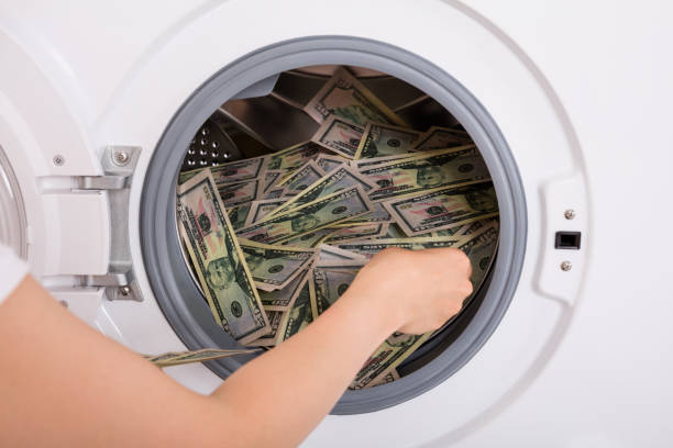 istock Person Inserting Money In Washing Machine 859435318