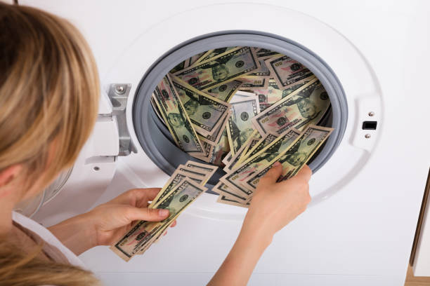 istock Person Inserting Money In Washing Machine 859435412