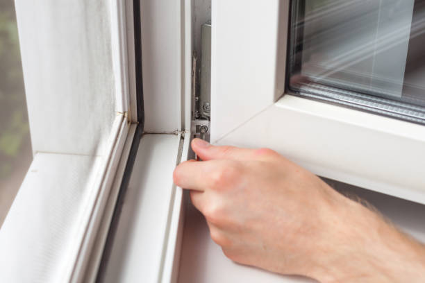 istock Handyman repairs plastic window with a hexagon. Workman adjusts the operation of the plastic window 859435598