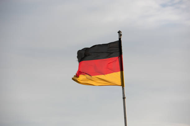 istock German flags in front of the sky 859435688