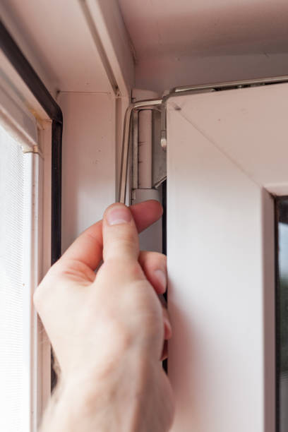 istock Handyman repairs plastic window with a hexagon. Workman adjusts the operation of the plastic window 859435854