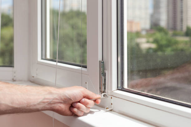 istock Handyman repairs plastic window with a hexagon. Workman adjusts the operation of the plastic window 859436110